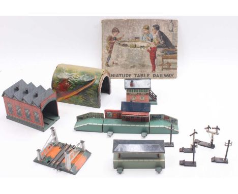 One box containing Bing tabletop 00 gauge accessories to include a tunnel, a clockwork engine shed, a 3-rail level crossing, 
