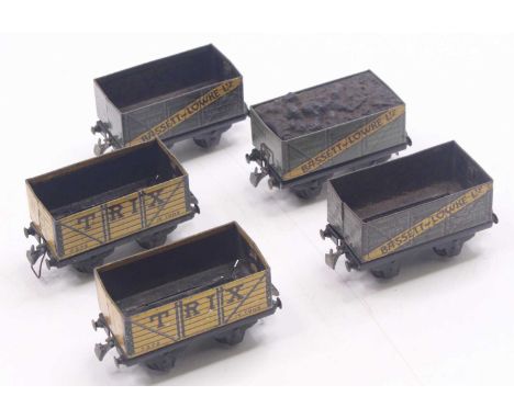 Five Trix Twin pre-war 00 gauge wagons to include three grey Bassett Lowke wagons, one with coal load, and two yellow Trix wa