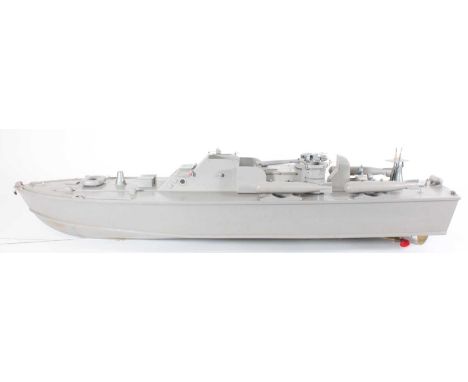 A Wooden hand built model of a Patrol Torpedo Boat painted in grey, having a removable super structure showing a petrol-drive