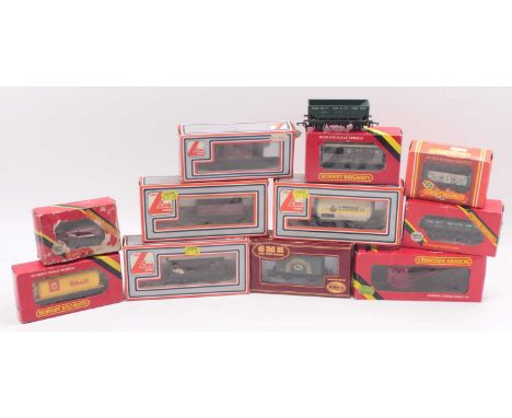 Two trays containing mainly early Hornby 00 gauge wagons and coaches, including a six-wheeled insulated milk van, a GWR resta