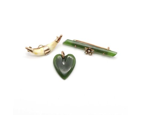 A nephrite and split pearl bar brooch,with a centre floral cluster of split pearls, rub set and grain set to the 9ct gold swi