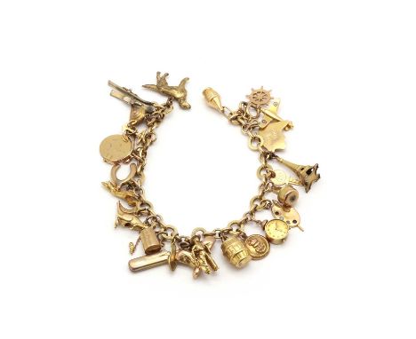 A gold charm bracelet,with alternating oval and circular links, with bolt ring clasp, suspending 26 charms, all marked or tes