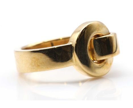 An 18ct gold ring, by Asprey,of garter form, with an Asprey signature to the top. London 2004. Head 12.10mm wide, 8.89g.Finge