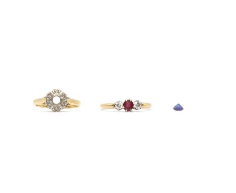 A ruby and diamond three stone ring,with an oval mixed cut ruby claw set to the centre, and an old brilliant diamond on each 