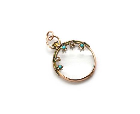 An Edwardian 9ct gold glazed locket pendant,of circular form, with an open glazed panel spectacle set to a 9ct frame, surmoun