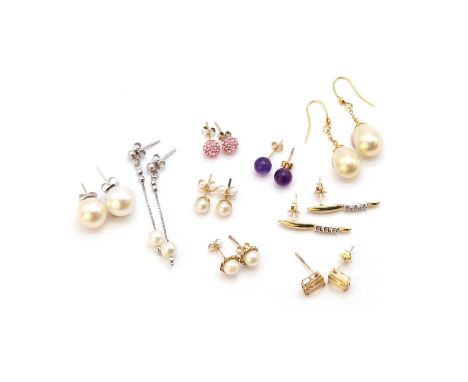 Nine pairs of earrings,to include a pair of two colour gold three stone diamond earrings, tested as approximately 9ct, a pair