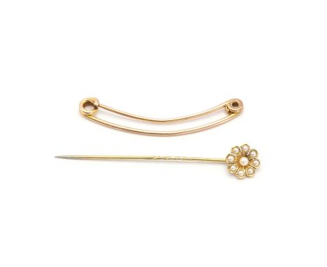 Two gold pins,to include a curved bar kilt pin, tested as approximately 9ct gold, and a gold split pearl stick pin, of flower