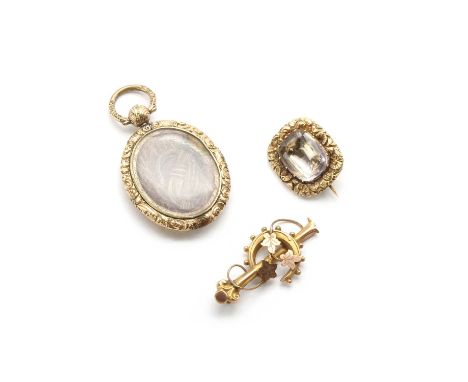 A rock crystal quartz brooch,with a cushion cut rock crystal quartz, claw set to cut down collet, to chased floral frame, wit