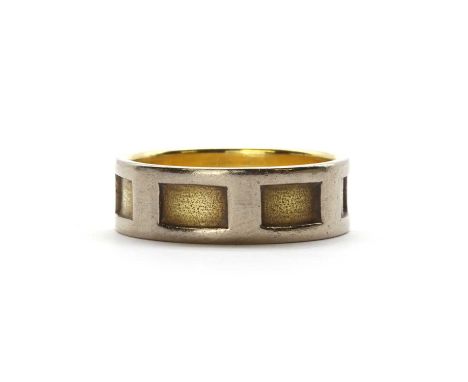 A two colour gold band ring,with rectangular inset gold panels and a white gold outer frame, to a flat section shank, tested 