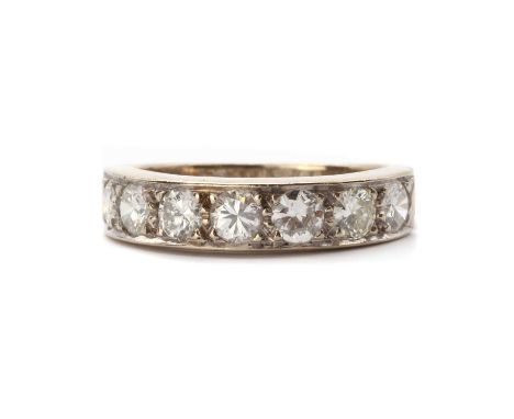 A white gold diamond half eternity ring, a row of brilliant cut diamonds, grain set, to a plain shank, tested as approximatel