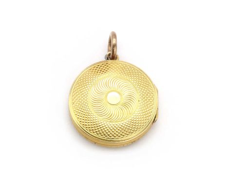 A gold memorial locket,of circular form, with engine turned engraving, a plaited hair glazed panel, to suspension loop and ju