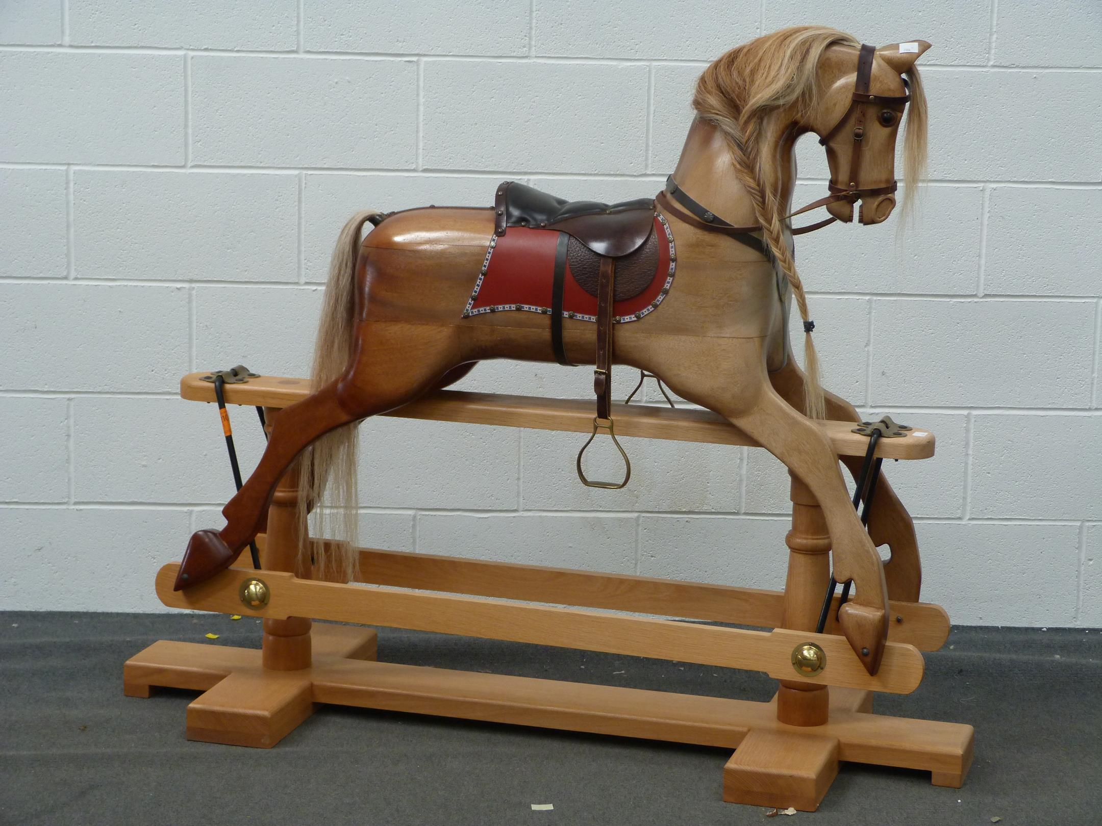 A Large Wooden Rocking horse with horse hair mane and tail with leather