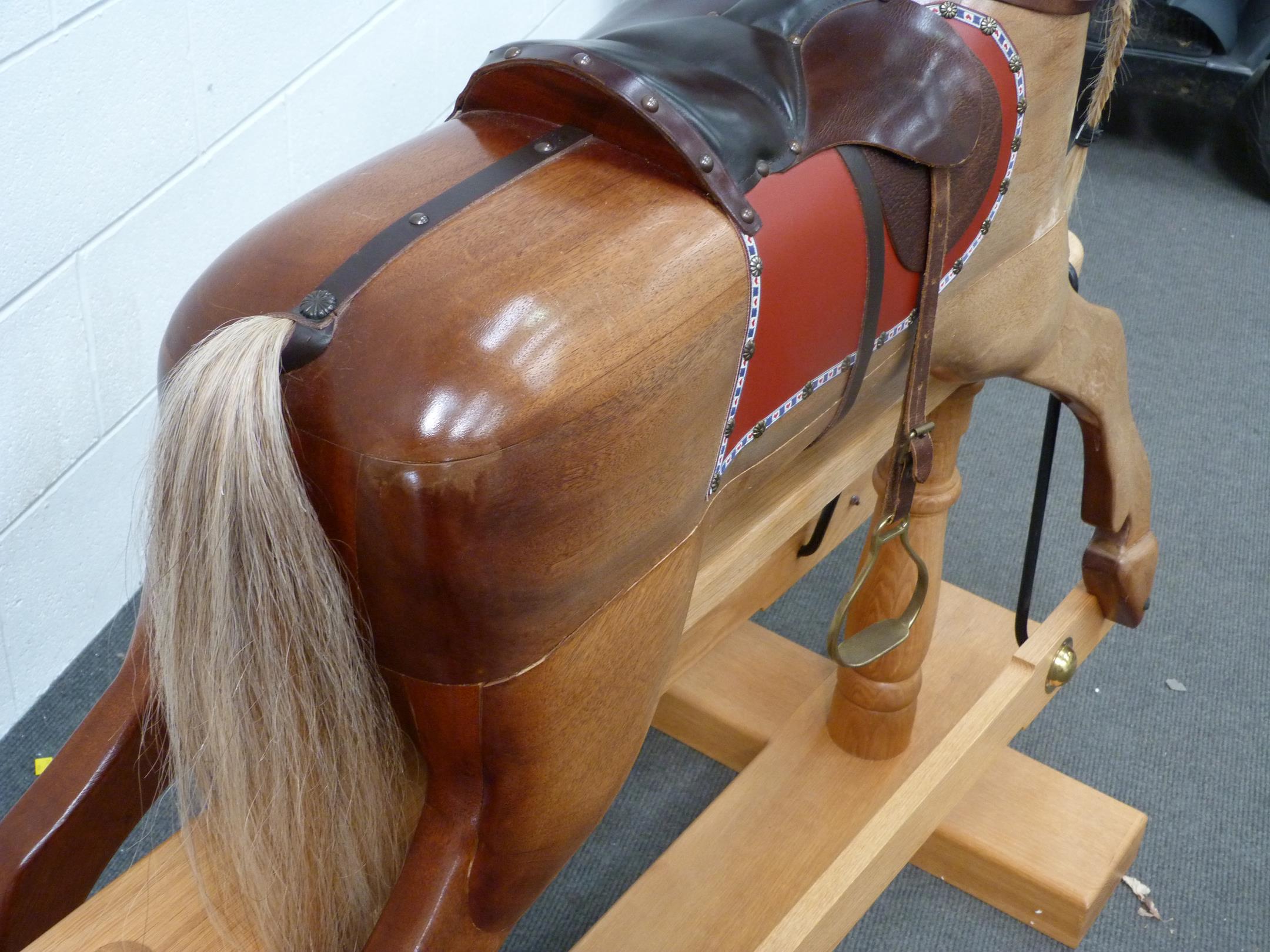 A Large Wooden Rocking horse with horse hair mane and tail with leather