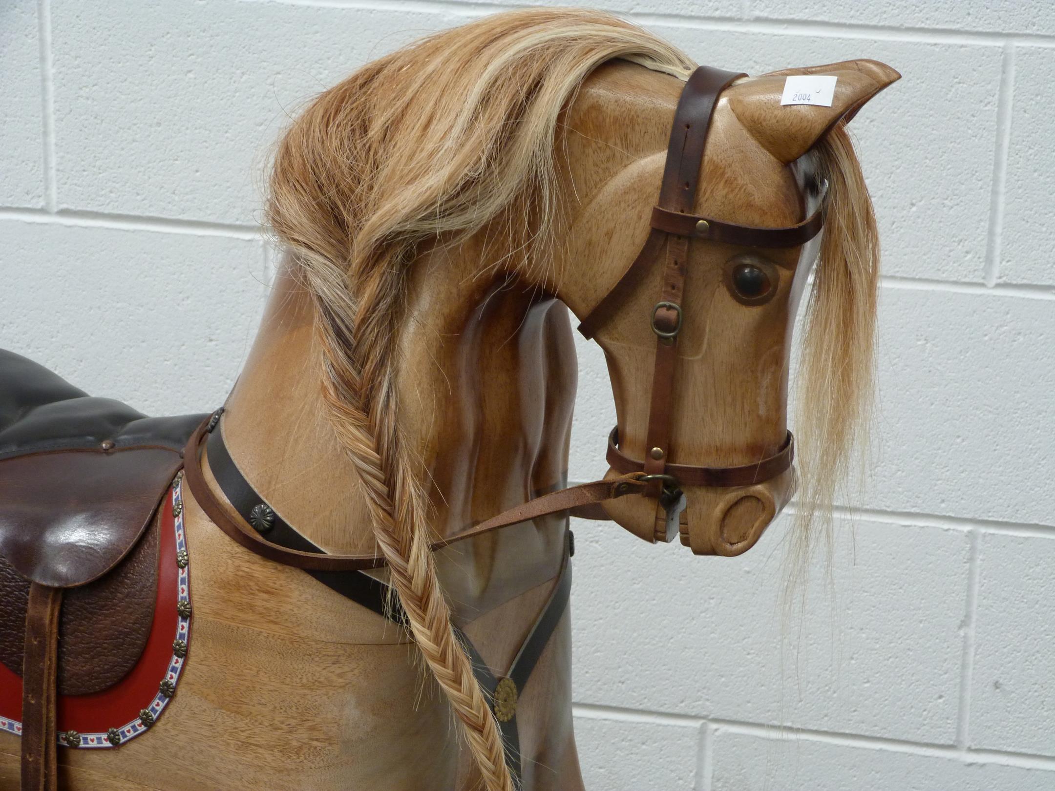 A Large Wooden Rocking horse with horse hair mane and tail with leather