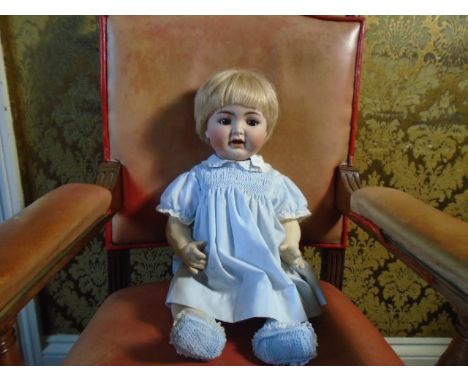 A vintage composite bisque faced doll, by Kammer + Reinhartd marked '126 Simon &amp; Halbig' with articulated limbs and head,