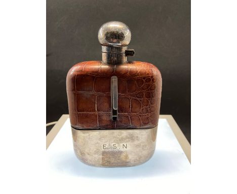 A silver-plate and leather bound hip flask with bayonet silver plate fitting, makers stamp , height 16cm. Condition: inscribe