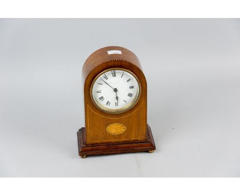 An Edwardian mahogany and boxwood strung mantel clock with Sheraton style fan motif, white enamel dial with Roman numerals (d