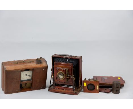 A Thornton Pickard mahogany cased bellows field camera, two mahogany plate holders, time shutter etc with associated film rol