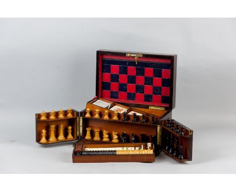 A Victorian rosewood games compendium, the lid with brass plaque and escutcheon, opening to reveal a leather covered games bo