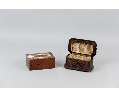 A mahogany lidded box opening to become a multi-wood inlaid cribbage board with inset bone counting holes and a German carved