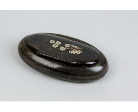 An oval 19th Century horn snuff box with floral silver inlay to the lid