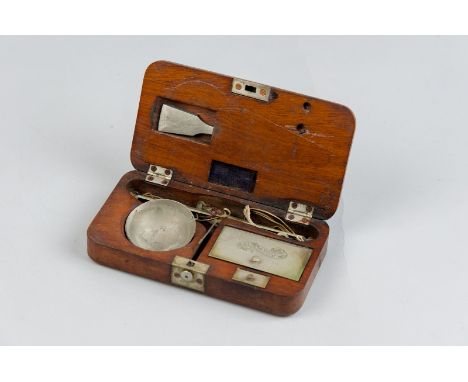 A wooden cased set of travelling scales, the lid of the weights recess bearing the names 'Bauer Munchen'