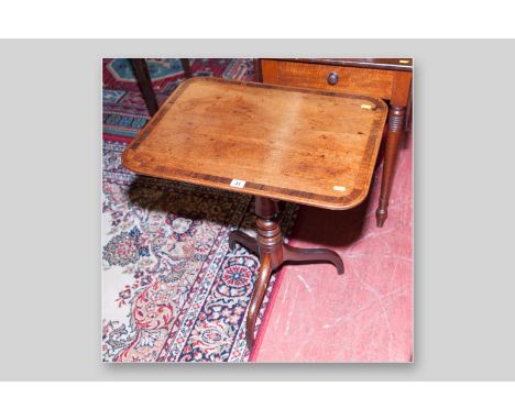 A Georgian mahogany tilt-top tripod table with rosewood crossbanded top and turned column support, 17.5 x 24 ins (45.5 x 61 c