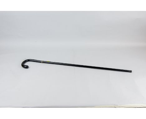 An Edwardian composition swordstick walking cane with hallmarked silver collar, with slight decoration above and below, small