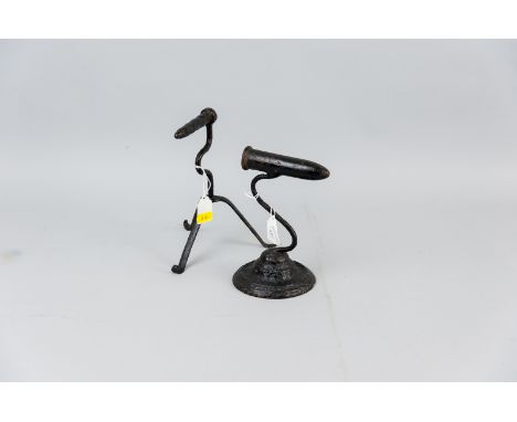 A 19th Century wrought goffering iron on tripod base along with a cast and wrought goffering iron on a circular base, 8.5 ins