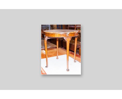 A circular burr walnut topped card table on Queen Anne supports, the top with brass clips and swivel action hinge and baize c