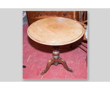 A Georgian mahogany tilt top tripod table with chamfered edge on a carved bulbous support with three splayed legs, 30.5 ins (