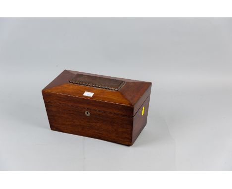 A 19th Century sarcophagus shaped walnut tea caddy on bun feet (one missing), the lift-up lid opening to reveal twin lidded t