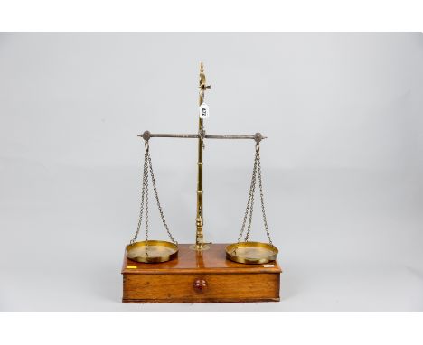 A set of W & T Avery brass and iron beam scales on a single drawer mahogany base, 24 x 16 ins (61 x 40.5 cms)