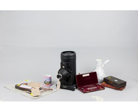 A cased Kodak Retina projector, a pottery improved earthenware inhaler, a pink lustre mug with a printed panel scene of Swans