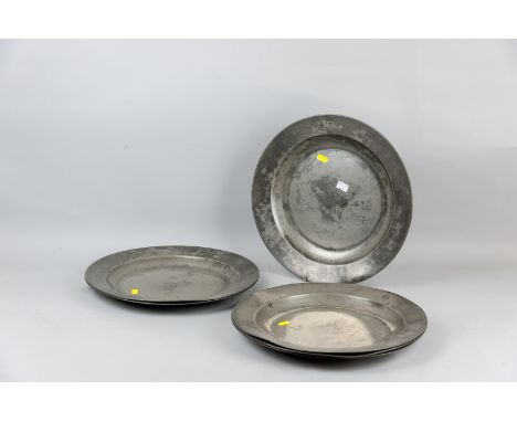 A set of six good sized pewter dished plates, all with folded rims and faint London marks, 14.75 ins (37.5 cms) diameter, (su