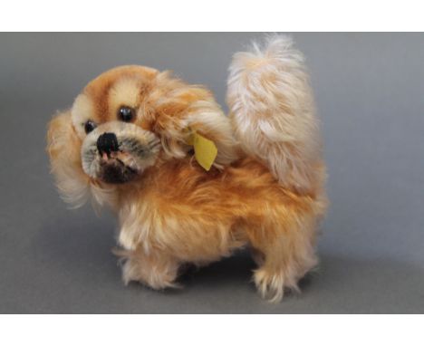 A Steiff Pekingese terrier, dated 1959-67. Measuring 10cm in height and with silver button and yellow tag to ear