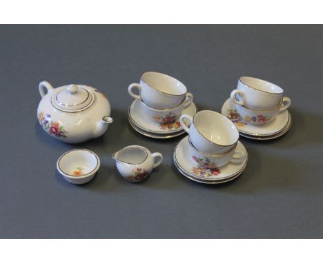 A Victorian floral decorated child's tea set comprising teapot, six tea cups, six saucers, milk jug and sugar bowl