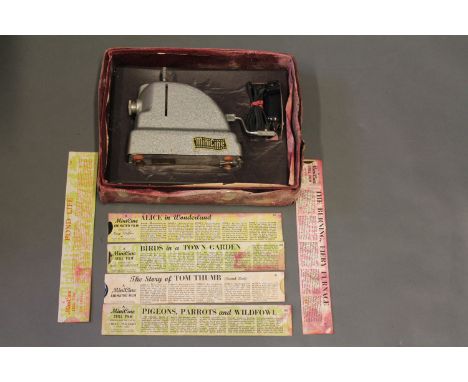A boxed Mini Cine projector and 6 slides 