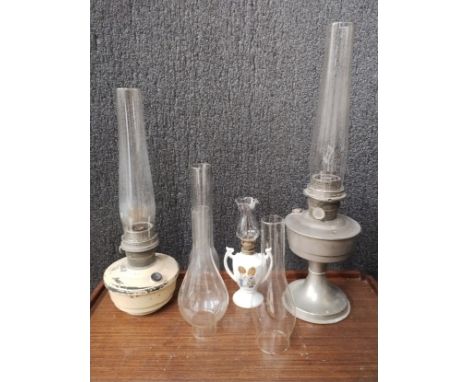 Two metal oil lamps with glass burners and a smaller lamp 