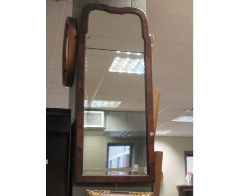A late 19th century/early 20th century walnut and marquetry framed bevelled mirror with shaped top having a bevel edge sectio