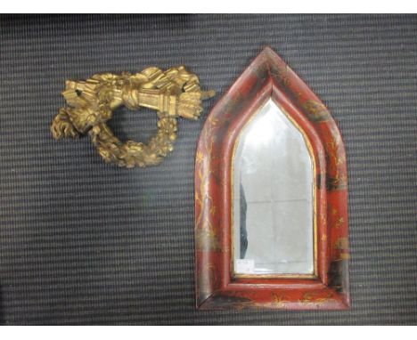 A red lacquer framed wall mirror of lancet shape, 36cm high and a carved giltwood cresting (2)  