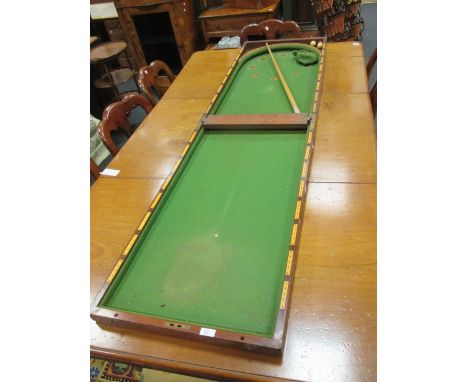 A mahogany table top bagatelle game  