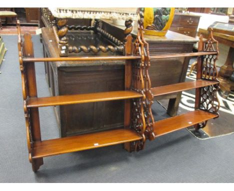 A pair of mahogany three tier wall shelf with fret carved sides, 69cm wide (2)  