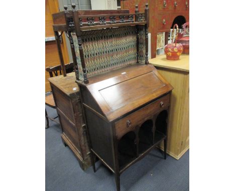 An Aesthetic movement walnut writing desk with spindle turned raised shelf back, and Liberty print lining  