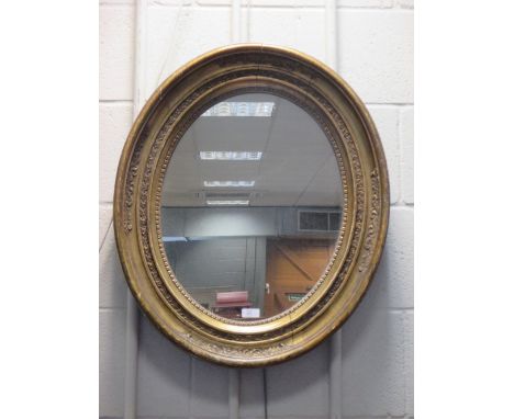 An oval gilt framed wall mirror  