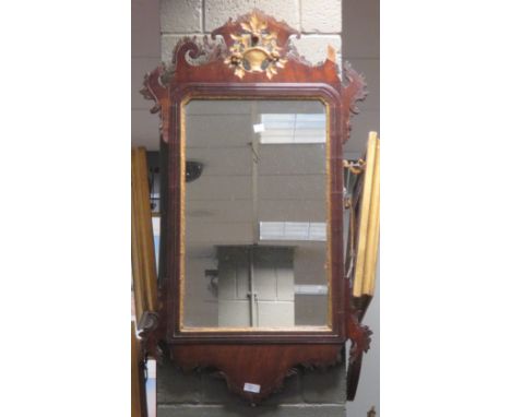 A Chippendale style wall mirror with fret carvings and gilded vase of flowers to the surmount  