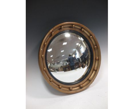 A convex mirror in gilt frame  