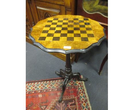A Victorian walnut games table on tripod base, 70cm high  