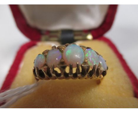 An 18ct five stone opal ring, the five graduated oval opal cabochons claw mounted to a plain tapering band, Birmingham 1902, 