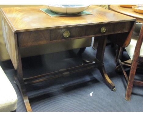 A mahogany sofa table in the Georgian style with rectangular end supports, turned stretcher rail and splay legs  